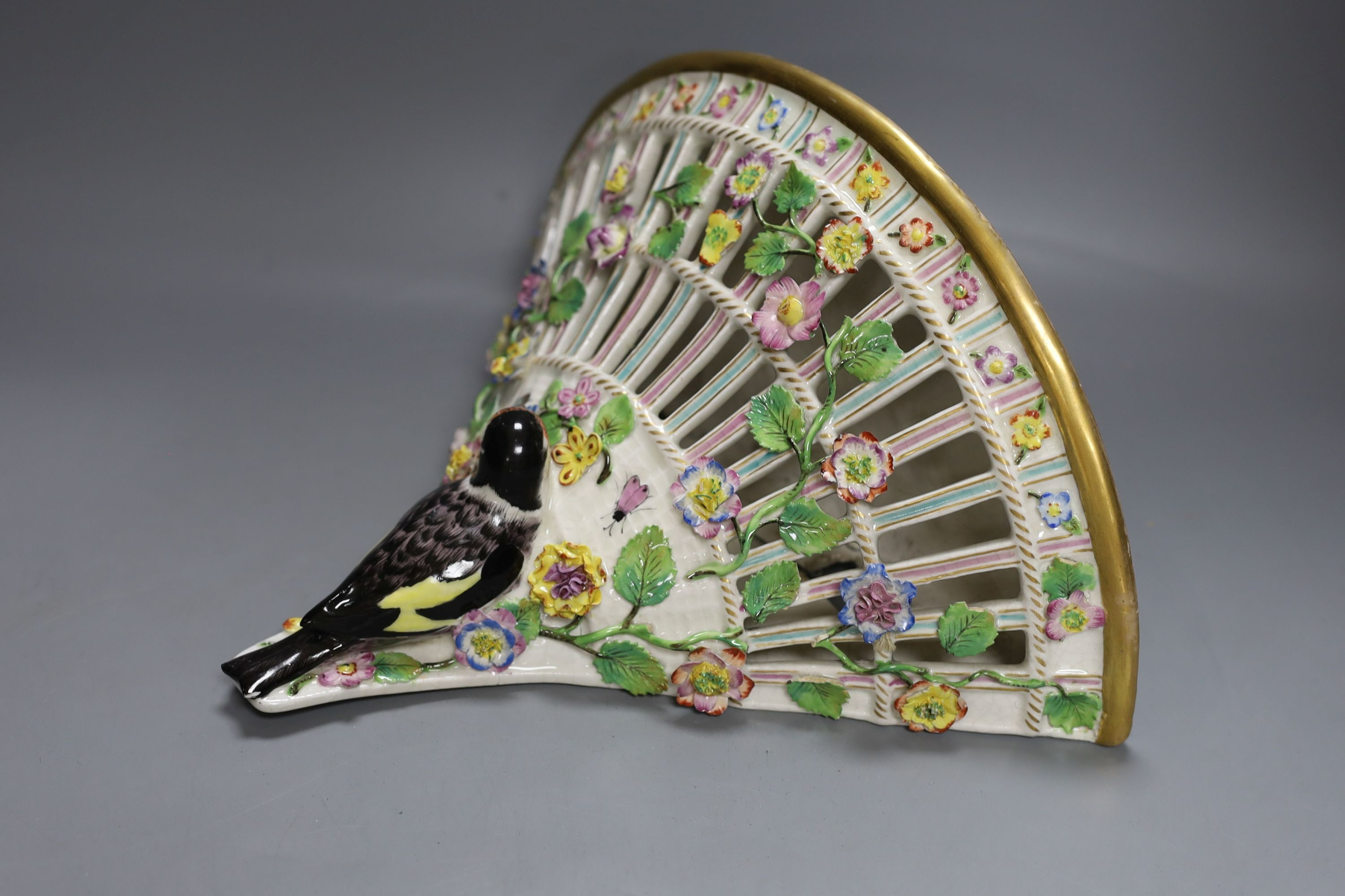 A late 19th century Sitzendorf cherub jardiniere, 18cm tall, and a porcelain floral wall bracket